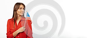 Banner size photo with copy space of a young blonde woman holding USA flag.