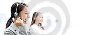 Banner of smiling telemarketing Asian woman in call center office photo