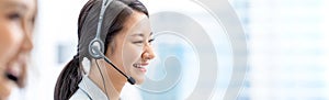 Banner of smiling telemarketing Asian woman in call center photo