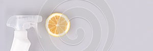 Banner - spray bottle with natural homemade household cleaner or air freshener made with lemon on light gray background with copy