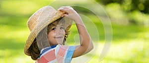 Banner with spring child face. Portrait of cheerful child in summer nature park. Cute joyful little boy kid. Close up