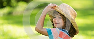Banner with spring child face. Portrait of cheerful child in summer nature park. Cute joyful little boy kid. Close up