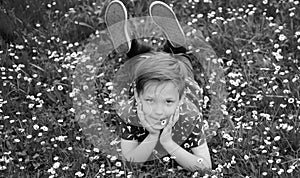 Banner with spring child face. Spring boy. Happy childhood. Smiling kid lying on grass. Dreaming concept. Kids on green