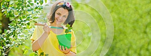 Banner with spring kids portrait. Little girl with pot. Lovely Child walking in spring garden. Child gardening in the