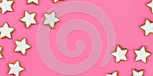 Banner with star shaped German cinnamon Christmas cookies called `Zimtsterne` on pink background with copy space