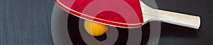 banner of table tennis or ping pong racket and ball on a black background