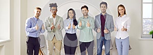 Banner with a team of happy diverse business people smiling and giving thumbs up