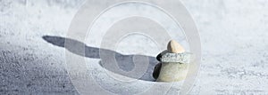 Banner theme of relaxation and meditation. Stones on gray background with space for copying. Balance and equilibrium.