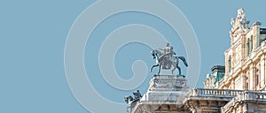 Banner with top roof sculpture of Greek goddess Muse riding Pegasus, a winged horse, at Vienna State Opera House, Vienna, Austria