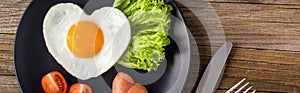 banner of Valentines day breakfast with heart shaped fried eggs served on grey plate