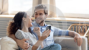 Banner view of happy couple celebrate win on smartphone