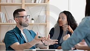 Banner view of multiracial colleagues brainstorm at meeting