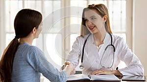 Banner view of smiling doctor handshake female patient