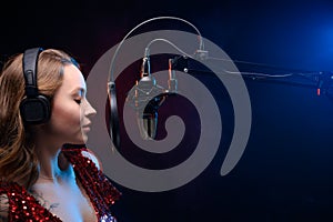 Banner for vocal lessons and music. A professional singer sings into a studio microphone. Screensaver for karaoke and vocal photo