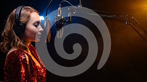 Banner. Vocalist sings in the studio. Practice and school of vocal. Music and teaching. Effective photo with blue and orange smoke