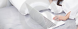 Banner website beautiful young asian woman with laptop lying dow