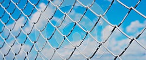 banner wor website, A fence made of wire mesh, netting covered with white on the background of blue sky and sunshine