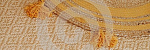 Banner woven mat with yellow tassels.