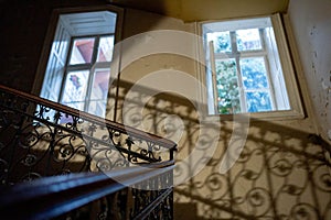 Bannister of stairs turing with two big windows around