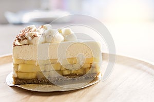 Banoffee pie with chocolate powder on wooden plate photo