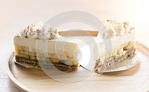 2 Banoffee pie with chocolate powder on wooden plate photo