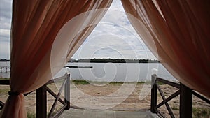 Banquet hall on the shores. Wedding ceremony on the shore. Decorated wedding table on the beach, soft evening light