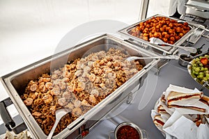 Banquet table with chafing dish heaters. Rice with shrimp