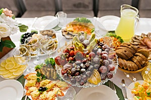 Banquet table with food and snacks at a wedding, birthday or party photo