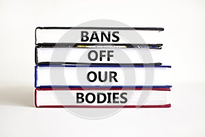 Bans off our bodies symbol. Concept words Bans off our bodies on books on a beautiful white table white background. Women rights