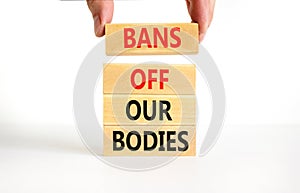 Bans off our bodies symbol. Concept words Bans off our bodies on wooden blocks on beautiful white table white background. Women