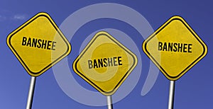 banshee - three yellow signs with blue sky background