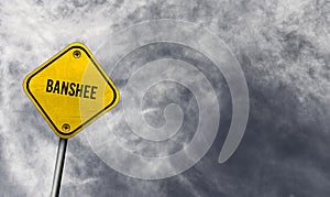 banshee - yellow sign with cloudy background