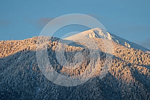 Bansko, Bulgaria. Snow mountain peak at sunrise