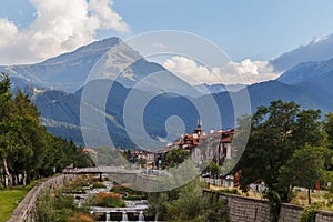 Bansko Bulgaria. View of Bulgarian ski resort at summer time peaks of Pirin mountains in the background .