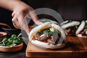 bao bun being filled with juicy and flavorful barbecue pork