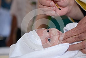 Baptism anointing baby