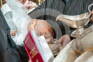 Baptism ceremony in Church. pour holy water on the head. Baptizing a Infant