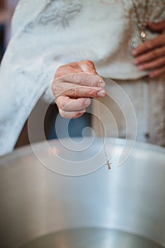 baptism of a child in the church, preparation of the ceremony, cross, holy water