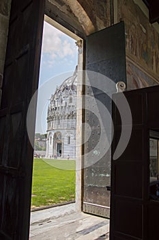 Baptistry of Pisa through the open door of Pisa Duomo, aka Cathedral