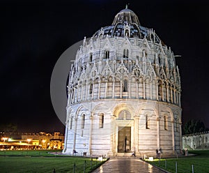 Baptistry of St John near the leaning tower of Pisa against a da