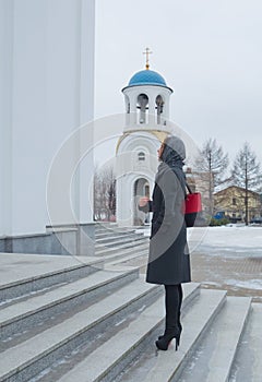 Baptized standing in front of Orthodox Church beautiful girl in a headscarf