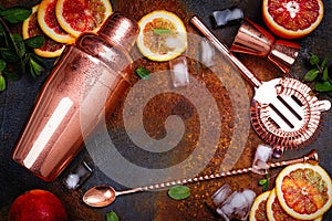 Bar accessories, drink tools and cocktail ingredients on rusty stone table. Flat lay style