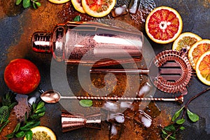 Bar accessories, drink tools and cocktail ingredients on rusty stone table. Flat lay style