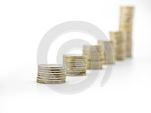 Bar chart made from coins isolated on white with free space for text. Silver coin stacks of different high.