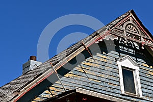 Bar clamps used to glue facia board on old house