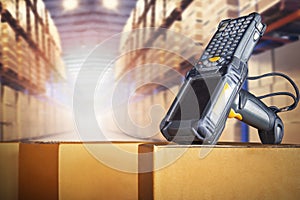 Bar Code Scanner on Packaging Boxes in Storage Warehouse. Shipping Storehouse. Computer Scanner Mobile Work Tools