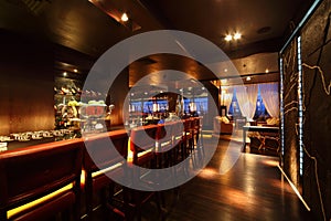 Bar counter with chairs in empty restaurant