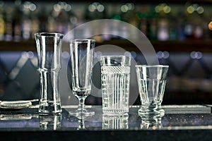 Bar counter with empty glasses. Assorted empty glasses and cocktail shots in the bar and restaurant. Glasses for alcoholic