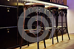 Bar counter with high chairs in cozy restaurant