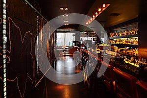 Bar counter with tall chairs in empty restaurant